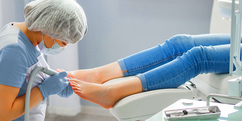 doctor treats toenail fungus